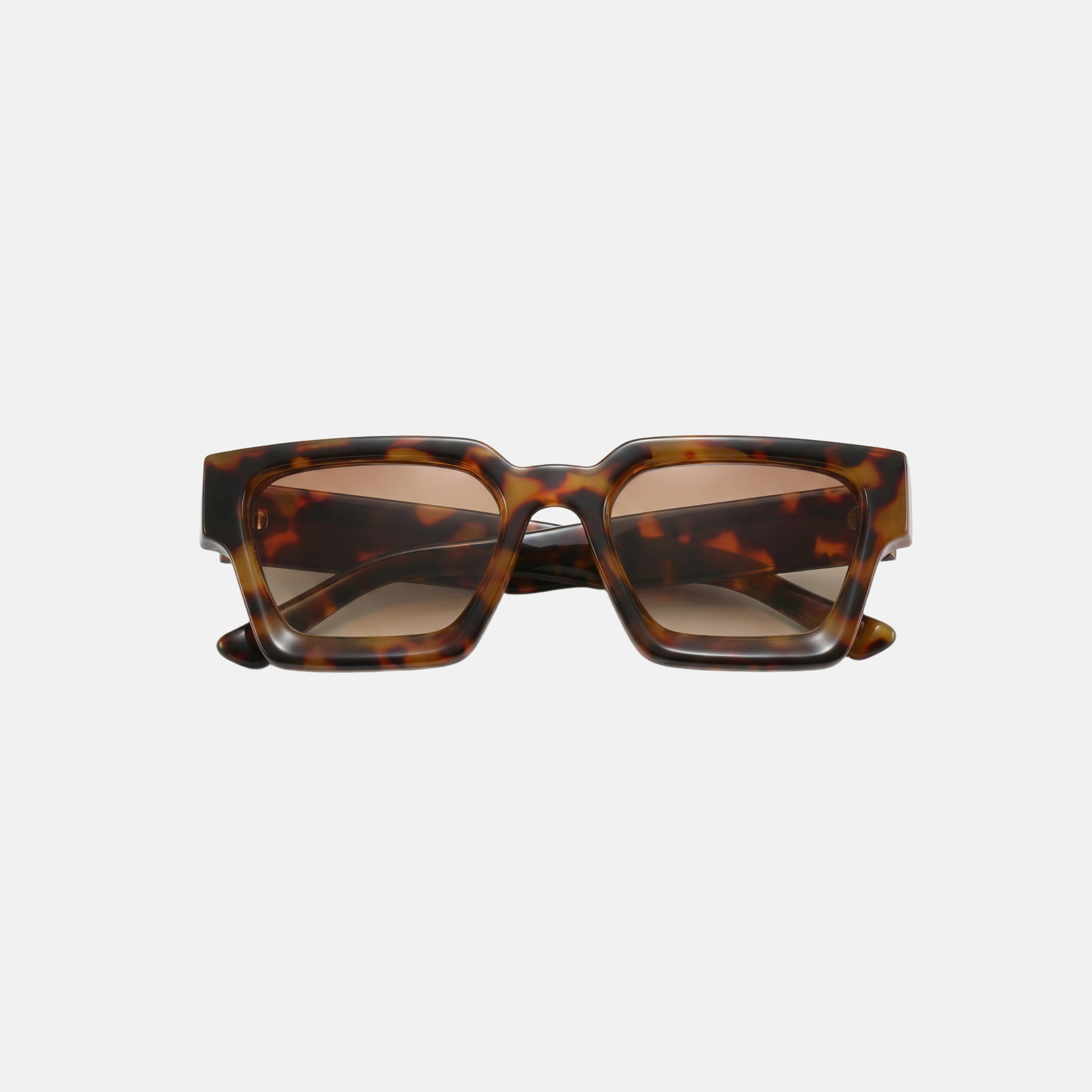 Tortoiseshell sunglasses on a light gray background
